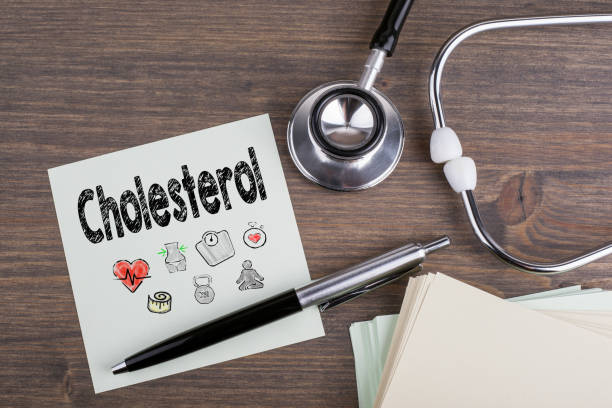 Cholesterol, Workplace of a doctor. Stethoscope on wooden desk background.